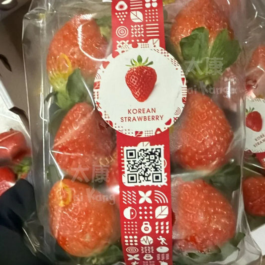 Fresh Korean strawberries in clear packaging with red label and QR code